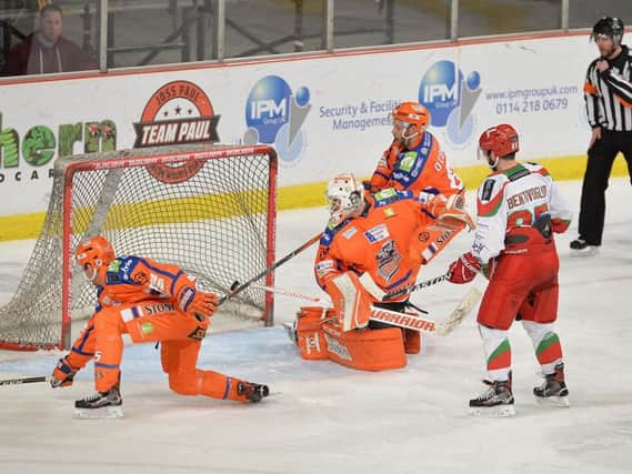 THREE STRIKES AND OUT: Sheffield Steelers' can only turn and watch after Andrew Hotham (hidden) slots home Cardiff's third goal. Picture: Dean Woolley.