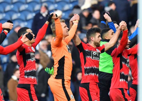 Huddersfield players celebrate at the final whistle.