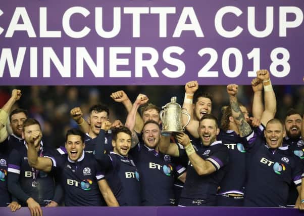 Scotland players celebrate with the Calcutta Cup.