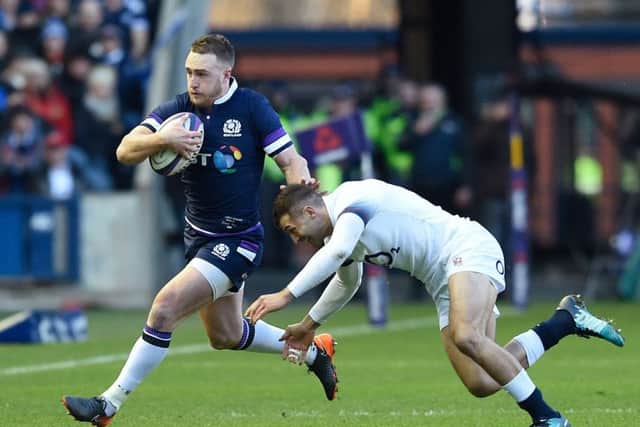 Scotland's Stuart Hogg, left, tries to get around England's Jonny May at Murrayfield. Picture: Ian Rutherford/PA