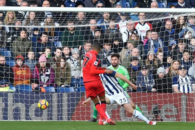 Huddersfield Town's Rajiv van La Parra scores his side's first goal at The Hawthorns. Picture: Anthony Devlin/PA