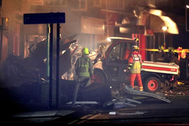 Emergency personnel load a small truck with debris at the scene on Hinckley Road in Leicester, after a "major incident" was declared by police after reports of an explosion at around 7.03pm.
