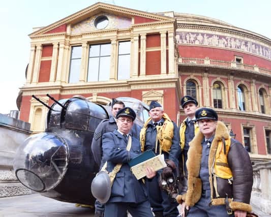 A RAF World War II re-enactor group wearing WWII uniforms stand alongside a 23ft Lancaster Bomber cockpit, ahead of the 75th anniversary event of the Dam Busters Raid, at the Royal Albert Hall in London.