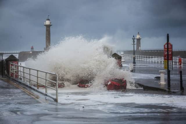 Large waves on the slipway in Whitby during a tidal surge. The huge waves lifted half-tonne sandbags off the slipway as well as washing away bins and an ice cream kiosk was lifted off its foundations. Onlookers said a woman was lifted off her feet and carried down Pier Road. Friday 13 January 2017.