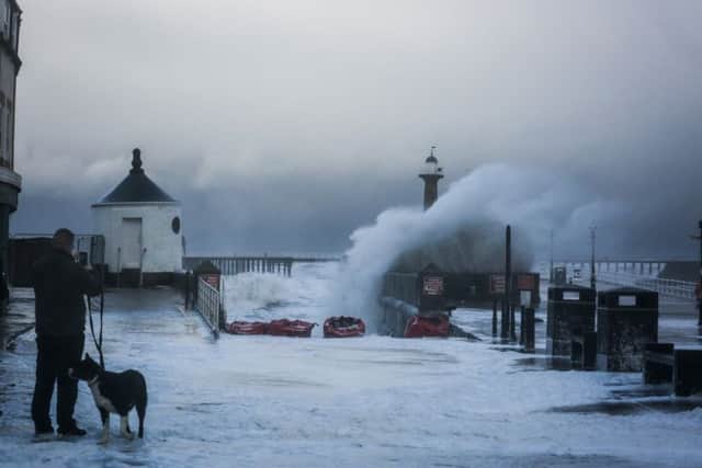 Large waves on the slipway in Whitby during a tidal surge. The huge waves lifted half-tonne sandbags off the slipway as well as washing away bins and an ice cream kiosk was lifted off its foundations. Onlookers said a woman was lifted off her feet and carried down Pier Road. Picture: Friday 13 January 2017.