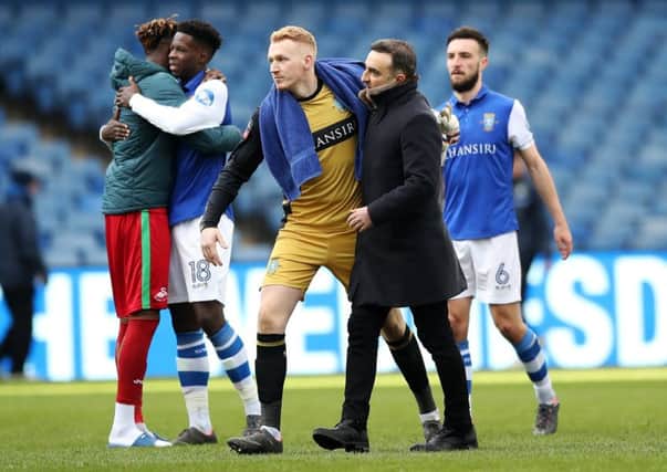 Goalkeeper Cameron Dawson is hugged by former Sheffield Wednesday head coach Carlos Carvalhal after the FA Cup draw with Swansea (Picture: Lynne Cameron/Sportimage).