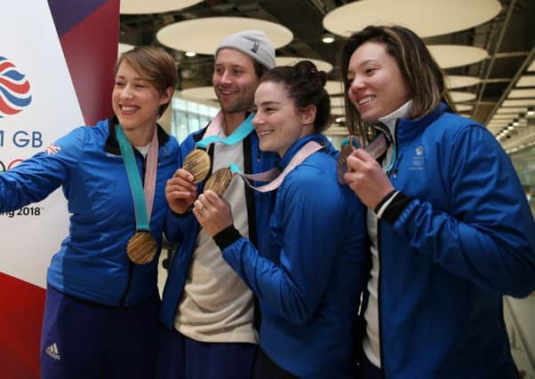 Great Britain's Lizzy Yarnold take a selfie with, Billy Morgan, Laura Deas and Izzy Atkin as Team GB arrive at Heathrow. Picture: Steve Paston/PA.