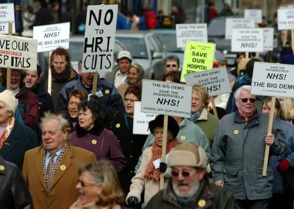 NHS campaigners march through Huddersfield.