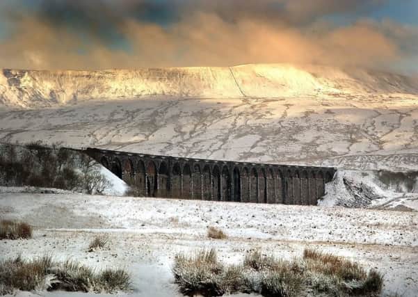 A snow storm lifts off Whernside and Ribblehead Viaduct. Picture by Bruce Rollinson.