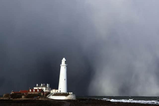 A snow storm over St Mary's Lighthouse in Whitley Bay, as heavy snowfall is affecting roads across the UK after several centimetres fell in some parts over the night. PA