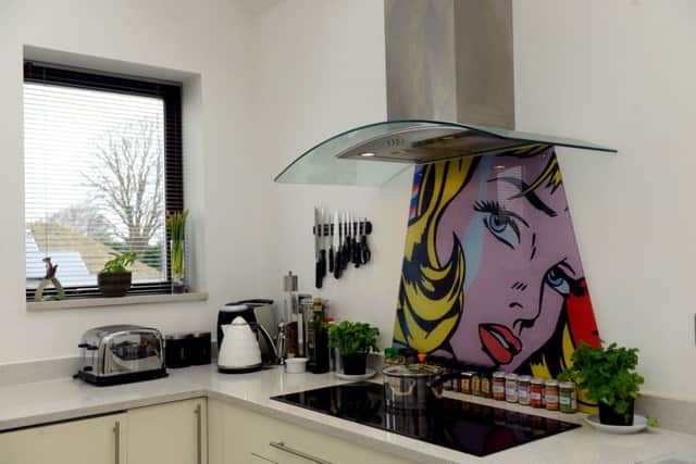 6The kitchen is part of a new extension on the converted school. The Lichtenstein-style splashback was Vanessa's idea and she commissioned it.