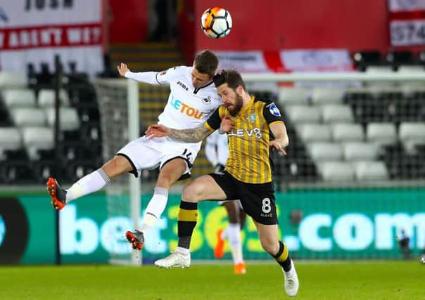 Swansea City's Tom Carroll (left) and Sheffield Wednesday's Jacob Butterfield battle for the ball (Picture: Nick Potts/PA Wire)