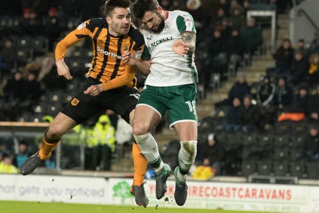 Clash of heads: Hull's Jon Toral and Barnsley's  Adam Jackson, who was stretchered off, collide.
  Picture: Bruce Rollinson