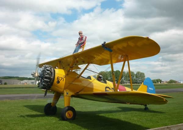 Jean Piper on the wing of an aircraft at Breighton Airfield for a fundraising stunt last year