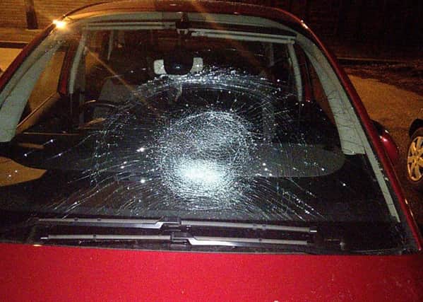 The damaged car windscreen.