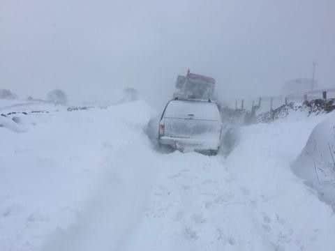 A district nurse is taken by tractor to a house call in Kettlewell