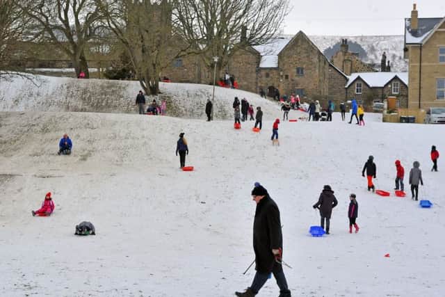 Children sledging in the snow at Riverside Gardens in Ilkley. Picture Tony Johnson.