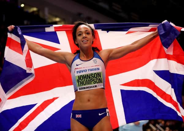 Great Britain's Katarina Johnson-Thompson celebrates with the Union flag after winning gold in the Women's Pentathlon.