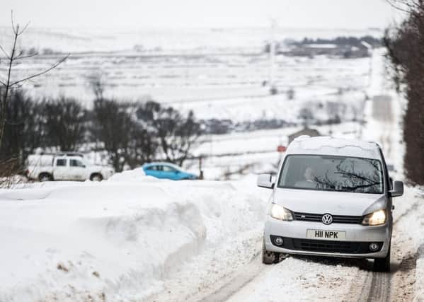 Cars navigate snowy conditions in Kirklees. PIC: PA