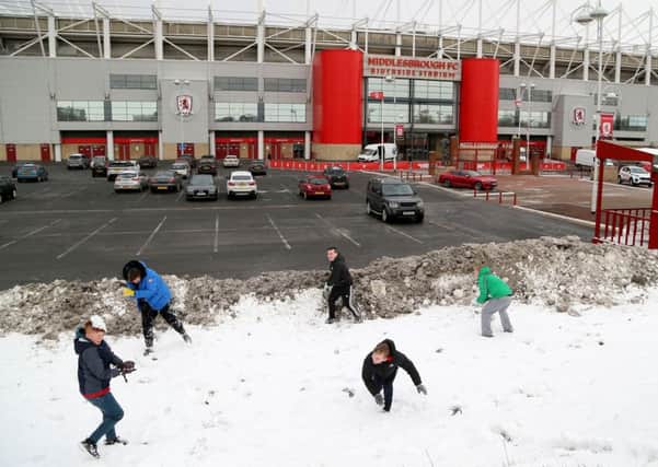 Children enjoy the snow outside Middlesbrough's Riverside Stadium before the Sky Bet Championship match between Middlesbrough and Leeds.
