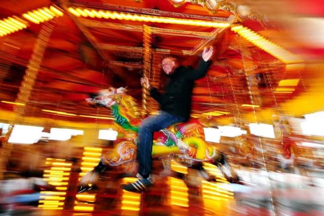 Auctioneer Carl Vince rides the carousel