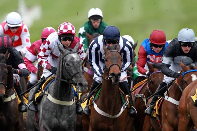 Countrywide Flame ridden by Dougie Costello (centre right) on their way to winning the JCB Triumph Hurdle in 2012.