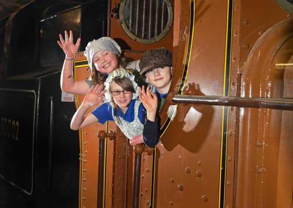 Katie Thornhill, 10, Summer Metcalfe, 9, Kyle Craven, 9,  dressed as the Railway Children on footplate of the original pannier tank used in the film in the engine shed at Oxenhope Station.
  Picture Bruce Rollinson