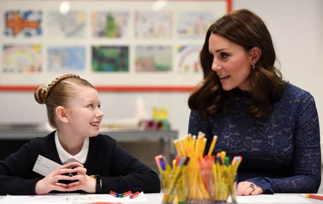 The Duchess of Cambridge speaks to Ruby, a pupil from Albion Primary School, during a visit to officially open the new headquarters of children's mental health charity Place2Be in central London.