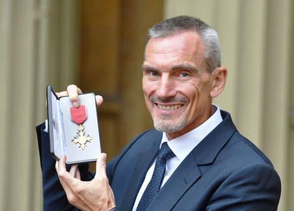 William Ward with his OBE following an investiture ceremony at Buckingham Palace