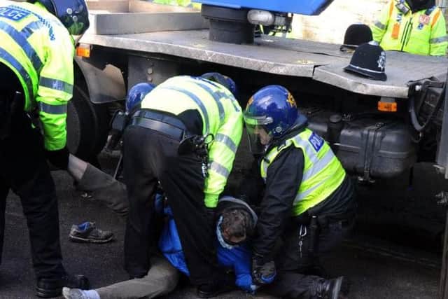 Police arrest a tree campaigner on Kenwood Road yesterday. Picture: Scott Merrylees