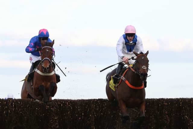 Waiting Patiently and Brian Hughes (right) lead Cue Card and Paddy Brennan away from the last fence before going on to win the Ascot Chase.