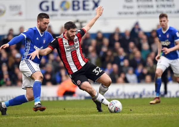 Ched Evans of Sheffield United is challenged by Luke Chambers of Ipswich Town at Portman Road. Picture: Robin Parker/Sportimage