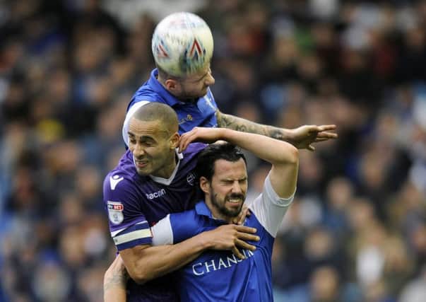 Jump: Owls pair Daniel Pudil and George Boyd squeeze out Bolton's Darren Pratley.