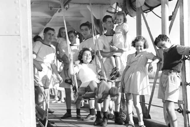British children, liberated from Japanese internment camps in Shanghai, China, being entertained aboard HMS Belfast in 1945. Imperial War Museum/PA Wire