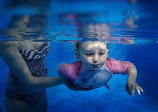 Dotty Rook, aged two, pictured under the water with her mother Lucy at Weighton Wold Farm in Market Weighton. Pictures by Simon Hulme.