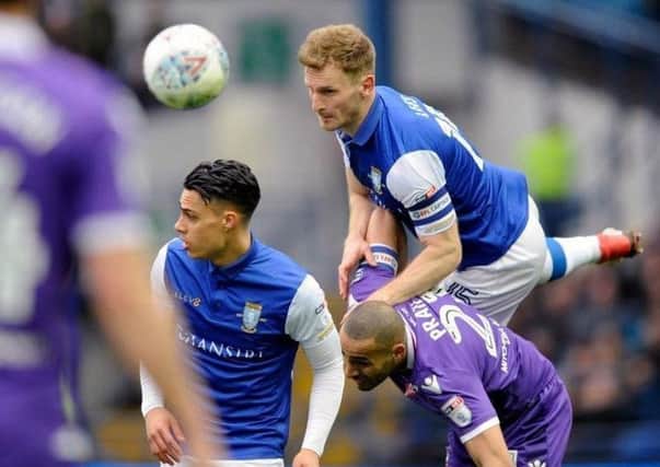 Sheffield Wednesday's Tom Lees gets to the ball ahead of Bolton's Darren Pratley (Picture: Steve Ellis).