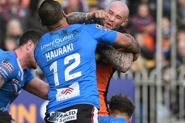 Castleford's Nathan Massey is tackled by Salford's Weller Hauraki and George Griffin.