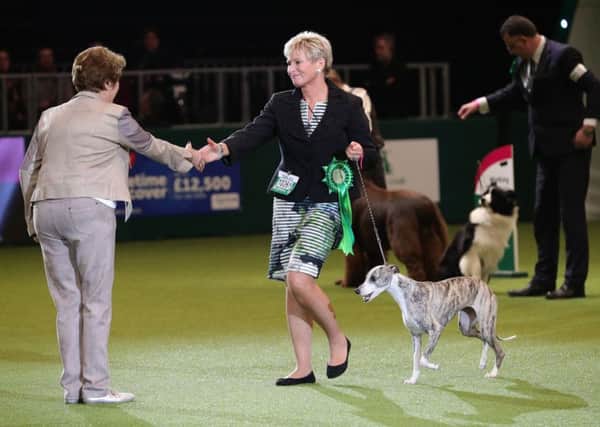 Tease, the Whippet, with owner Yvette Short after she was named Supreme Champion during the final day of Crufts 2018 at the NEC in Birmingham.
