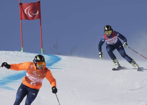 Britain's Millie Knight, right, and guide Brett Wild compete in the women's super-G, visually impaired, at the 2018 Winter Paralympics in Jeongseon.