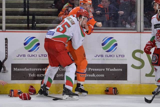 Matt Marquardt lands a punch on Cardiff's Tyson Strachan during their third-period set-to. Picture: Dean Woolley.