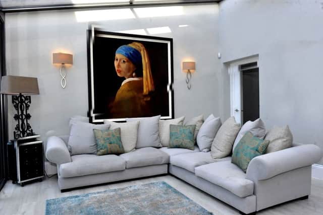 The new sitting area in the living kitchen with sofa from Raft and a copy of the Vermeer painting "Girl with a Pearl Earring".