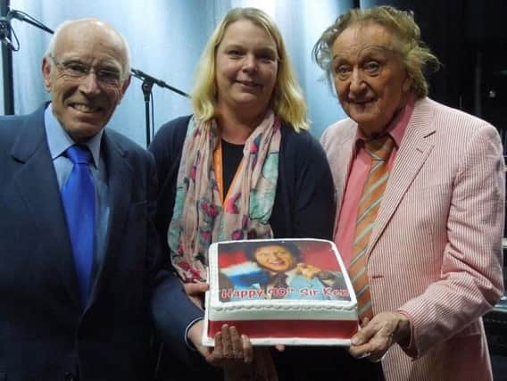 Ken Dodd, right, receives a birthday cake from Mike Hine and Mary Stalker, the Royal Hall's assistant front of house manager.