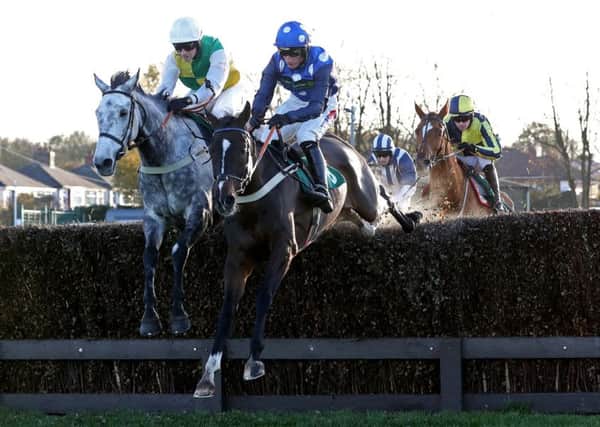Vintage clouds, left, in winning action at Aintree.