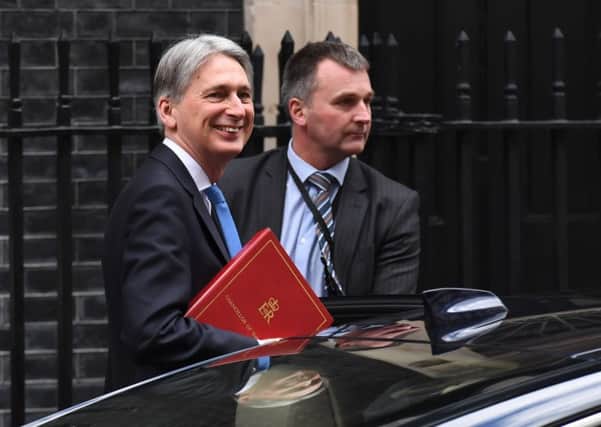 Chancellor of the Exchequer Philip Hammond (left) leaves 11 Downing Street as he heads to the House of Commons, London, to deliver his first spring statement against a slew of positive economic indicators. PRESS ASSOCIATION Photo. Picture date: Tuesday March 13, 2018. With an expected drop in borrowing, higher-than-predicted GDP growth of 1.7% for 2017 and the recent elimination of the Government's deficit on day-to-day spending, Mr Hammond is expected to tell MPs that the UK is reaping the reward for years of austerity. See PA story POLITICS Statement. Photo credit should read: Stefan Rousseau/PA Wire