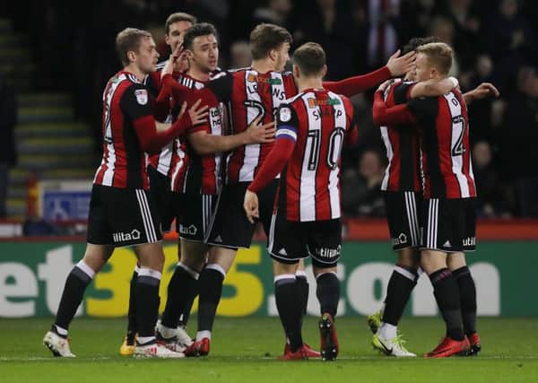 Enda Stevens is congratulated after setting Sheffield United on their way to their victory against Burton Albion at Bramall Lane last night (Picture: Simon Bellis/Sportimage).