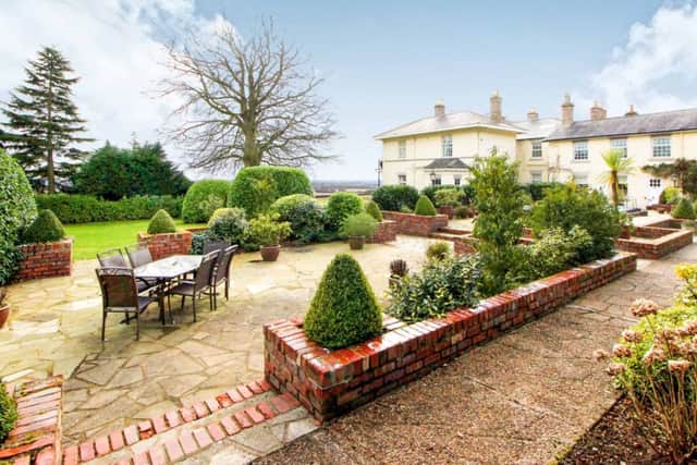 The grounds stretch to 1.1 acres and have views of the Wolds