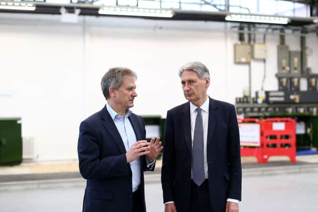 Chancellor Philip Hammond with Clive Selley, Openreach Chief Executive as he is given a tour of the Openreach training centre and fibre-optic engineering site in Bradford where he announced a Â£67m investments for businesses and homes to benefit from full fibre broadband connectivity.. PRESS ASSOCIATION Photo. Picture date: Thursday March 15, 2018.  Photo credit should read: Jan Kruger/PA Wire