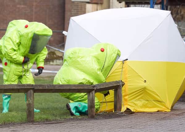 Personnel in hazmat suits work to secure a tent covering a bench in the Maltings shopping centre in Salisbury, where former Russian double agent Sergei Skripal and his daughter Yulia were found critically ill by exposure to a nerve agent.