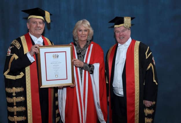 The Duchess of Cornwall receiving her honorary doctorate in recognition of her commitment to promoting literacy and celebrating literature from  Chancellor Gyles Brandreth (left) as she attends the University of Chester's graduation ceremony in Chester Cathedral