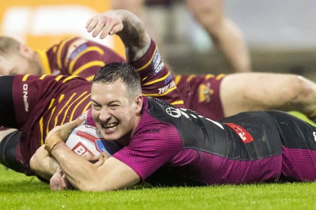 Hull KR's Danny McGuire scores a try against Huddersfield.